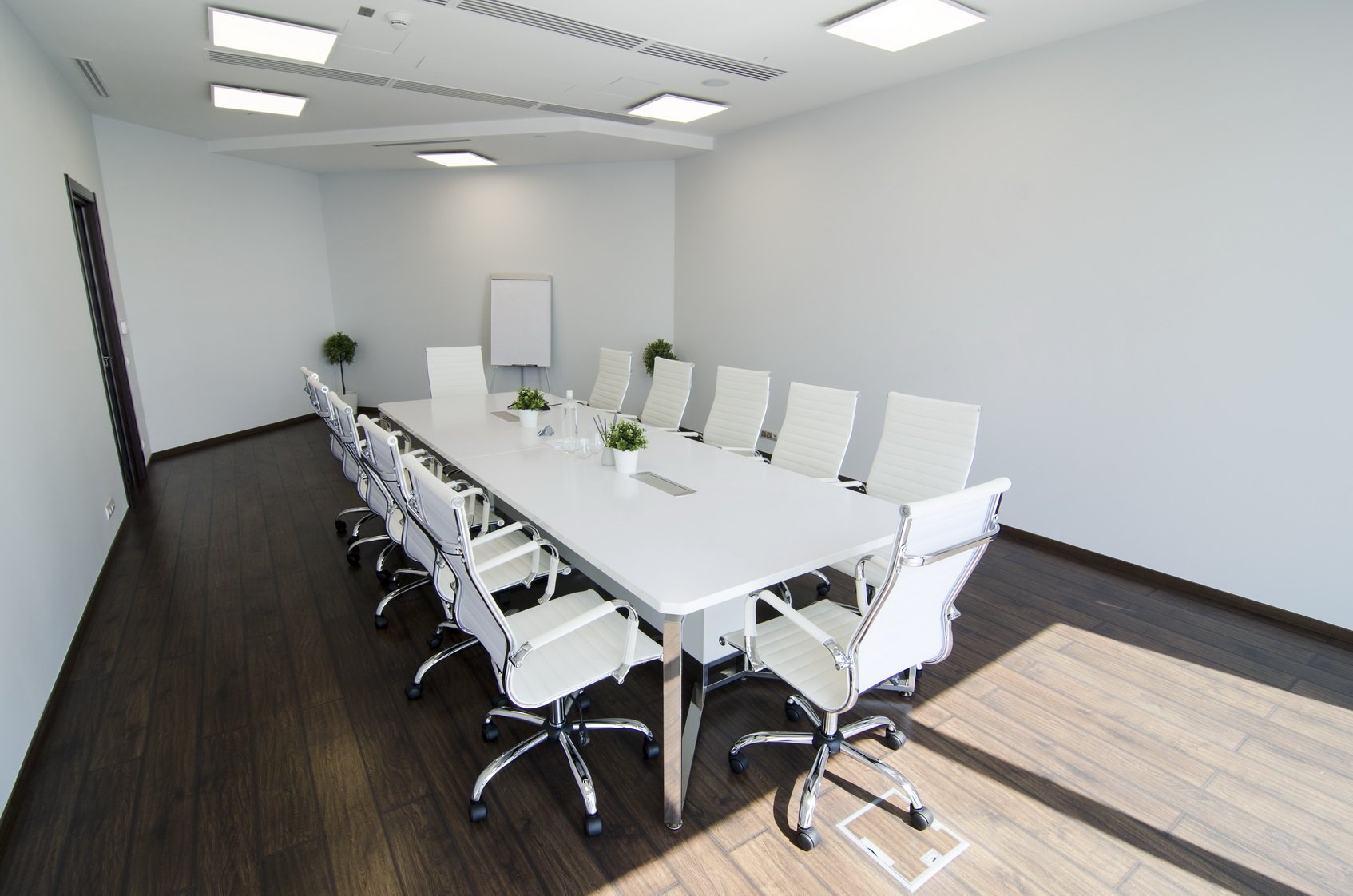 Белый стол для проведения переговоров со светло-бежевыми креслами